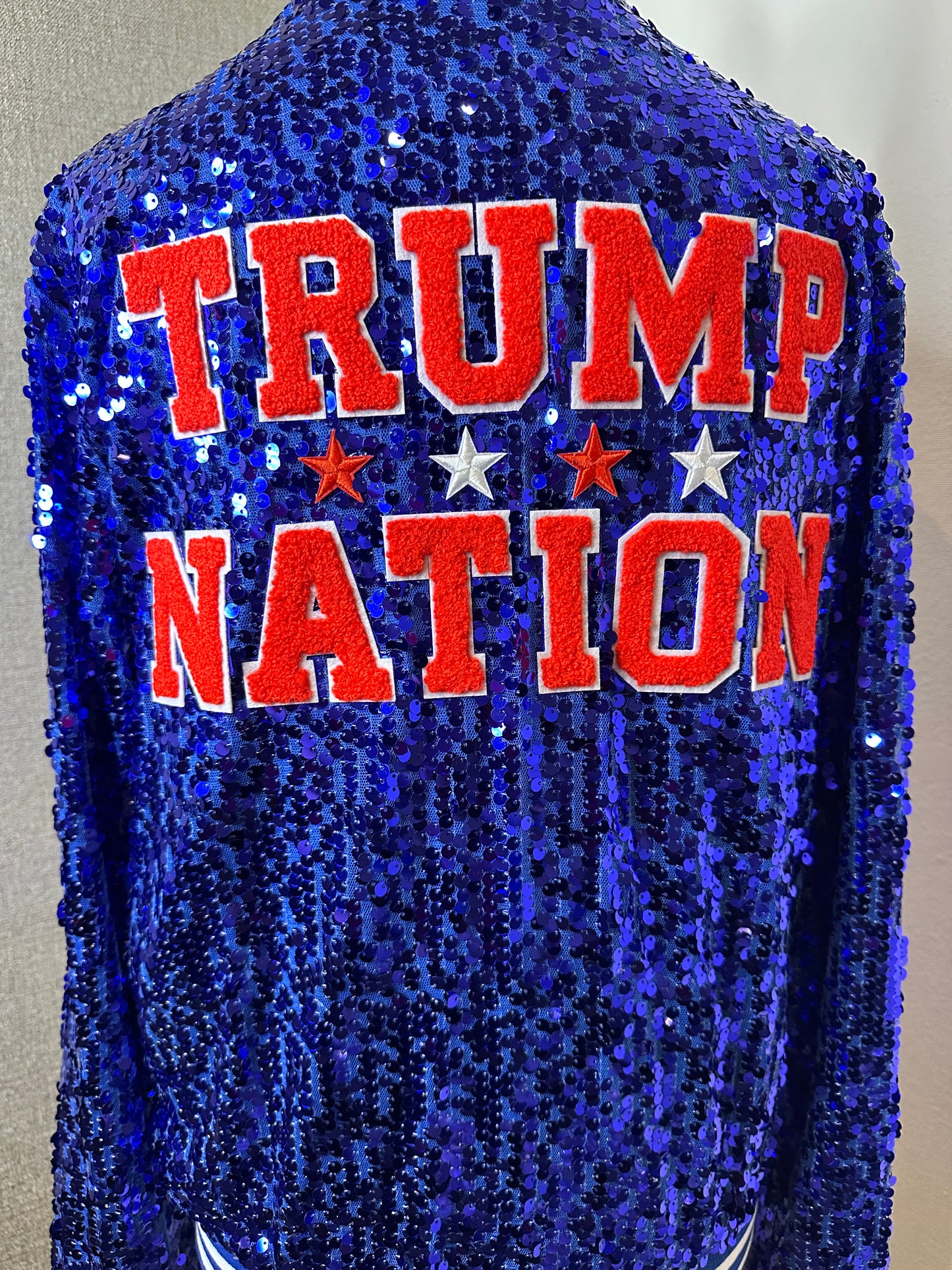 Blue”Sequin “AMERICA” adorned on the front. “TRUMP NATION” on the back. MAGA down the sleeve. USA patch flag on sleeve. ￼