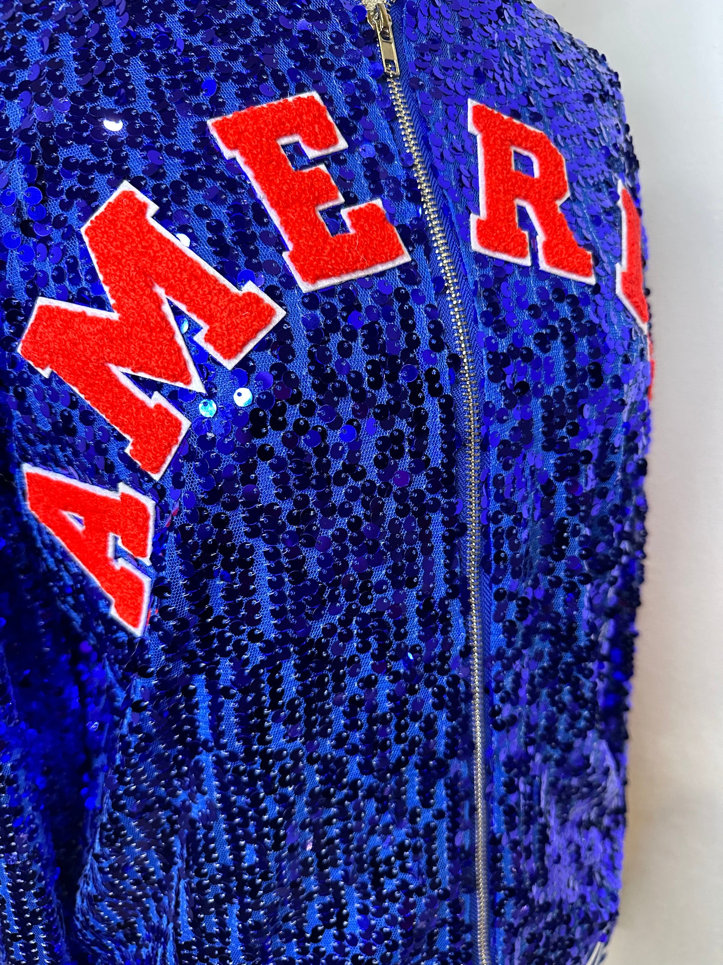 Blue”Sequin “AMERICA” adorned on the front. “TRUMP NATION” on the back. MAGA down the sleeve. USA patch flag on sleeve. ￼